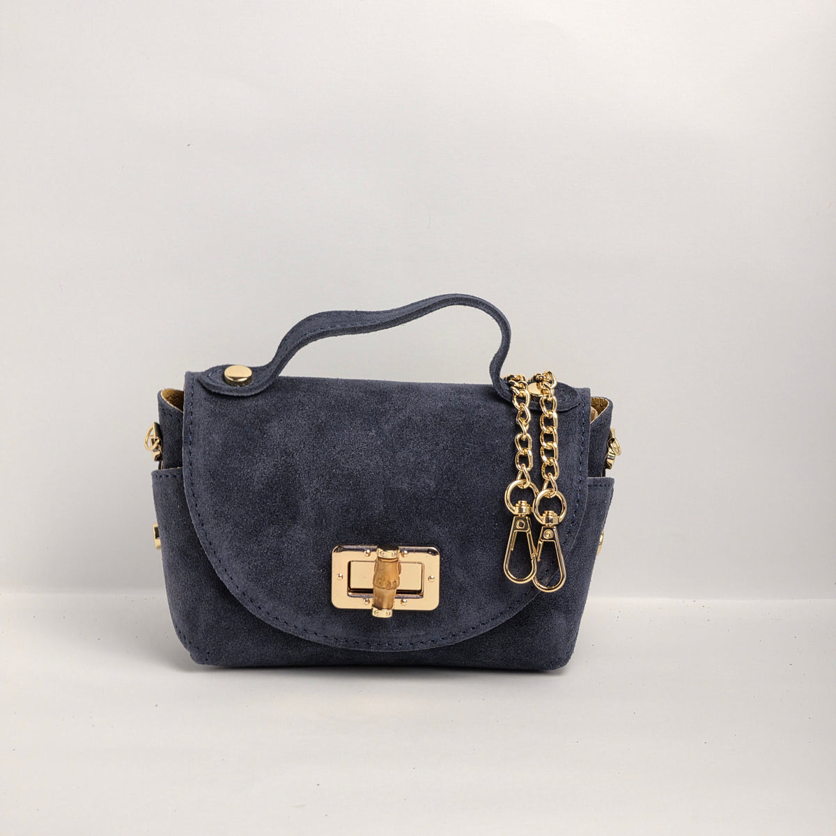 Mini bolso de mano en piel de ante azul marino