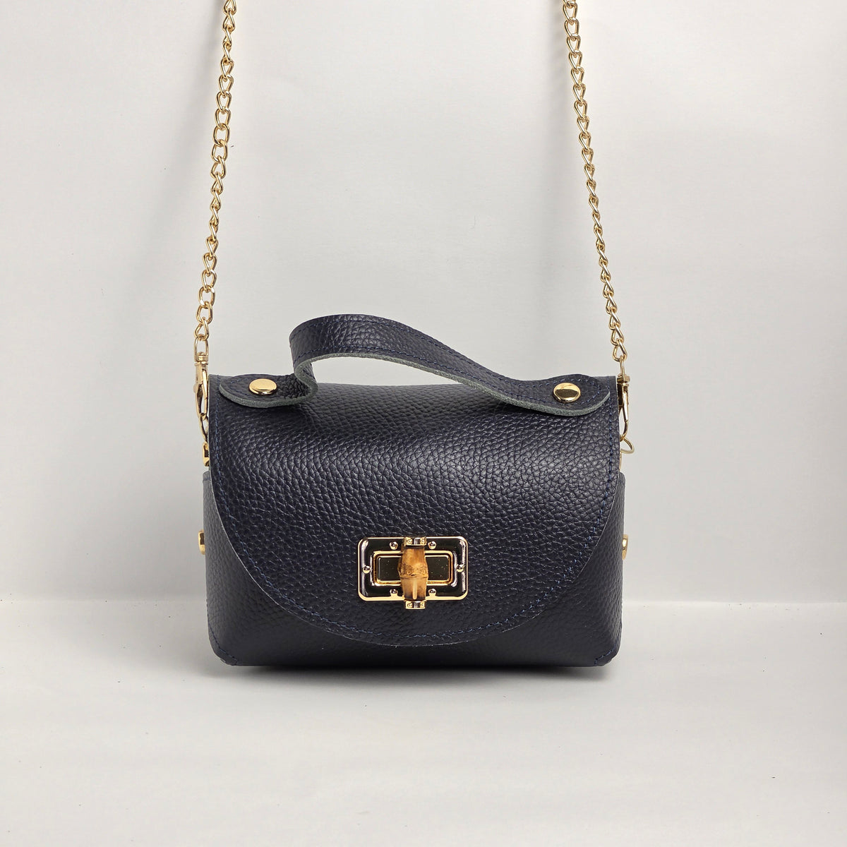 Mini bolso de mano en piel azul marino